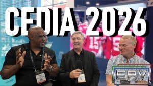 Three men discussing projection screens at CEDIA 2026 event.