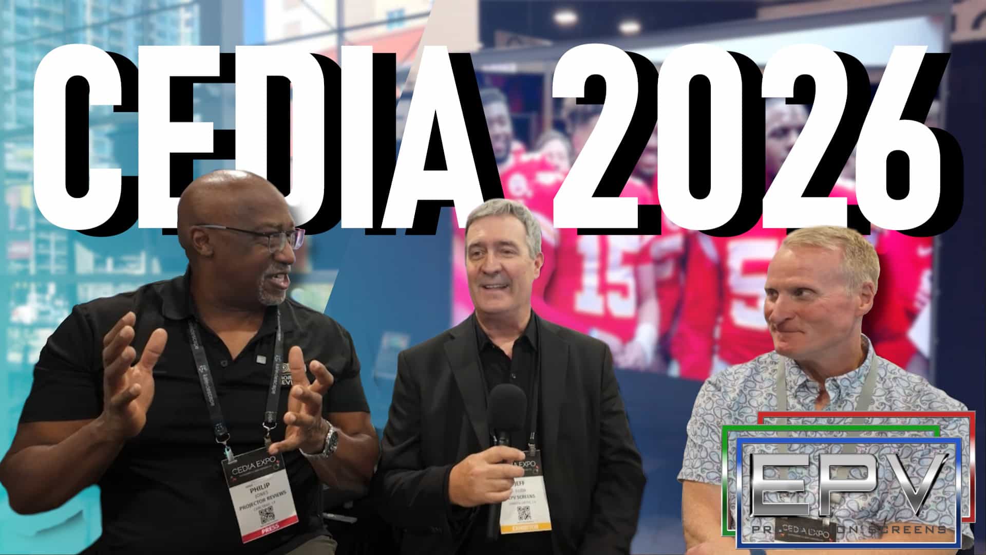 Three men discussing projection screens at CEDIA 2026 event.