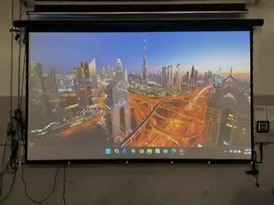 EPV Screens projection screen displaying Dubai skyline with city lights.